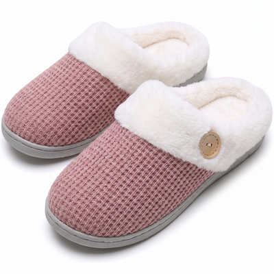 Pink knit slippers with plush cuff trim on white background