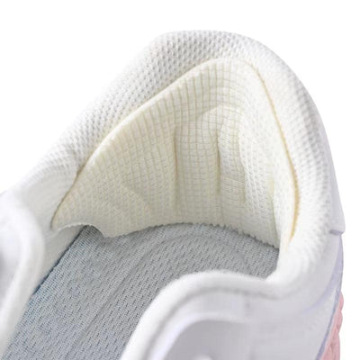 Beige heel pad installed inside white athletic shoe heel