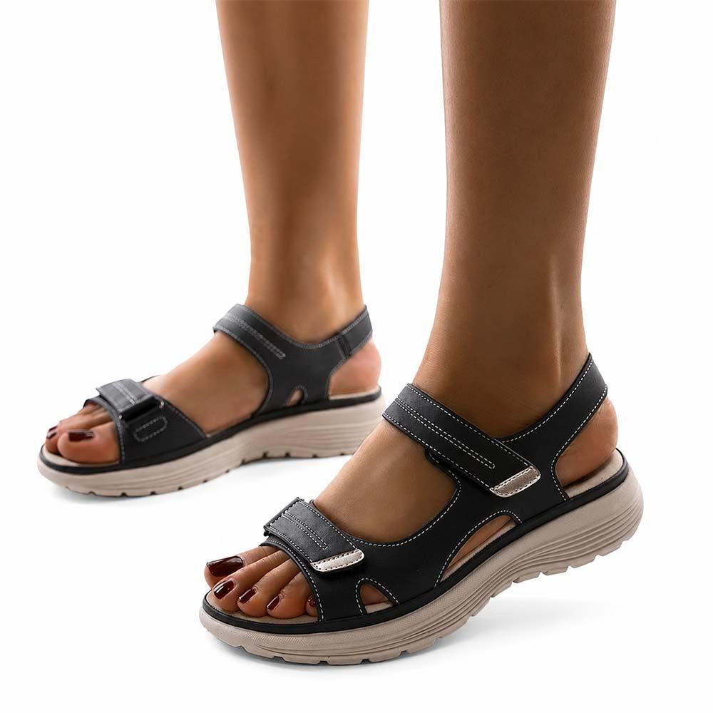 Blue arch support sandals worn outdoors on white background