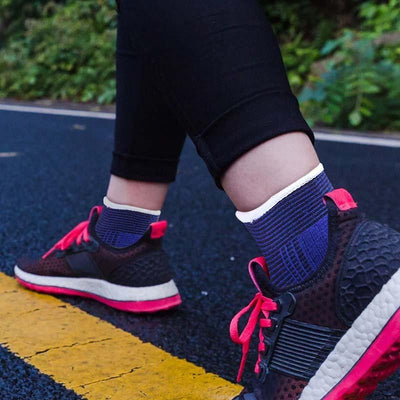 Ankle sleeve worn under sock with running shoe outdoors