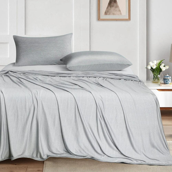Cooling blanket draped on a bed in Scandinavian bedroom