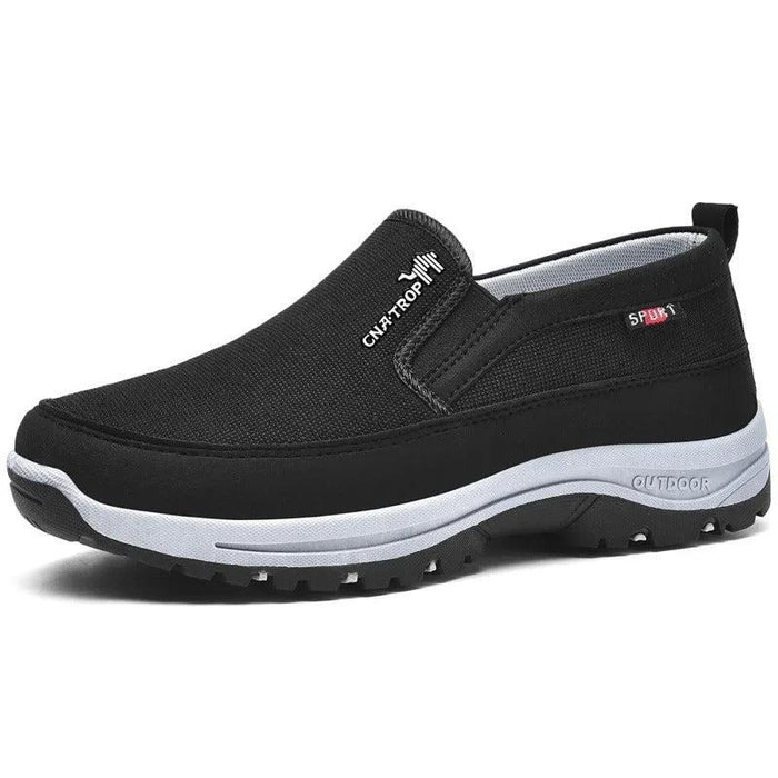 Black slip-on shoe with arch support sole on white background