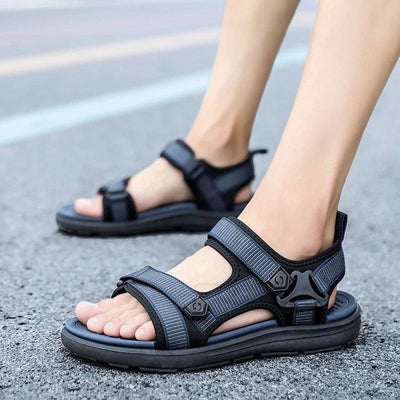 Blue shock-absorbing sandals worn walking on asphalt