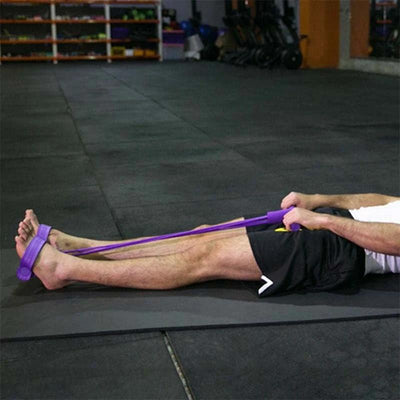 Person performing rowing exercise with purple resistance band