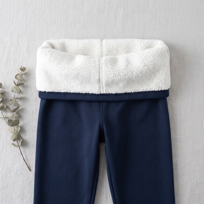 Navy blue thermal leggings with the waistband folded to show the white fleece lining