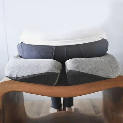 Person seated on memory foam cushion from rear, cushion on wooden bench